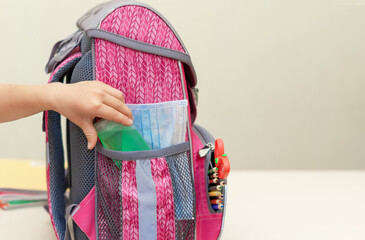 Back to school. Education concept. Collect your backpack for school. A child puts a protective...