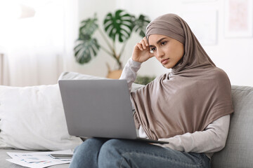 Freelance Stress. Annoyed arab woman tired after work on laptop at home