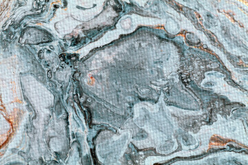 Macro detail of an abstract painting showing an imaginary underwater scene in grey and white tones with some golden sparkles and visible canvas texture. 