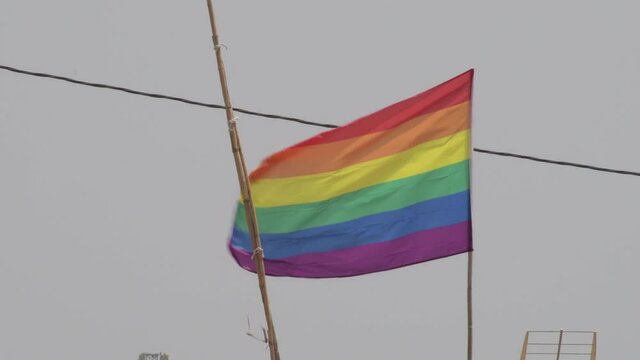 Real rainbow flag, LGBT pride flag or gay pride flag waving at wind a summer day