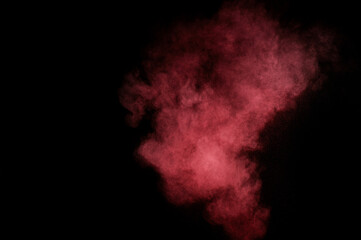 Fototapeta premium Red and pink powder explosion on black background. Colored powder cloud. Colorful dust explode. Paint Holi.