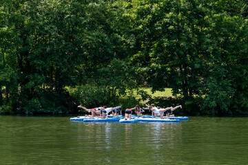Fototapeta na wymiar female paddleboard yoga class on the Neckar River in Stuttgart