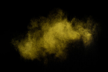 Yellow powder explosion on black background. Colored powder cloud. Colorful dust explode. Paint  Holi.