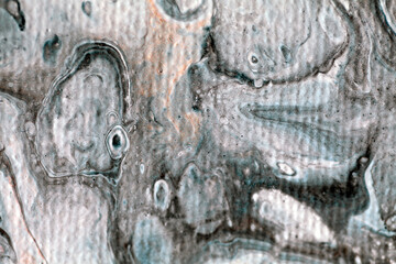 Macro detail of an abstract painting showing an imaginary underwater scene with a teddy bear and a one eyed puppet, in grey and white tones with visible canvas texture and blurriness, creating depth. 