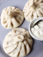 Delicious khinkali with meat and sour cream