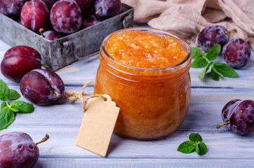 Yellow plum jam in a glass jar