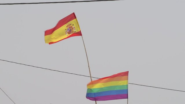Lgbt flag and spain flag waving