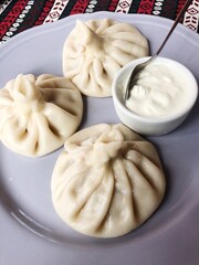 Delicious khinkali with meat and sour cream