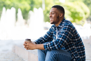 Portrait of african american guy sitting with coffee