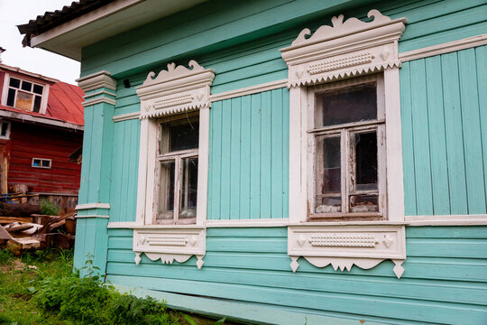 Russian traditional wooden house in the village, windows with carved platbands