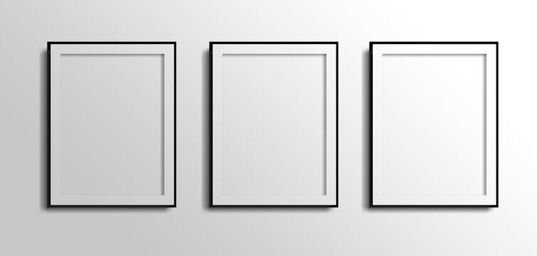 three vertical fotos frames,  3d white blank on grey white wall with black borders 