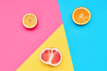 Citrus fruits on abstract geometry colored paper texture minimalism background