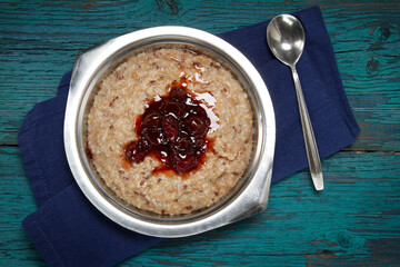 Oat bran and flax seeds porridge with gooseberry jam