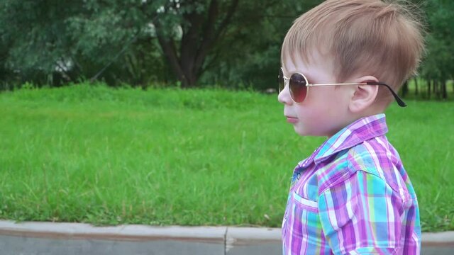 Boy in sunglasses walking