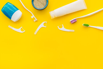 Concept of oral cleaning with toothbrushes, dental floss, tooth powder. Top view