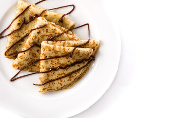 Sweet crepes with chocolate isolated on white background. Top view. Copy space