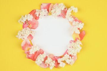 Circle blank paper with flowers on yellow background.