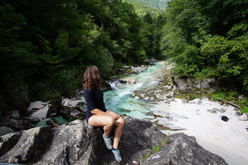 woman sitting up the river