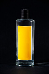 Lemon cologne. Transparent glass bottle isolated on black background. Various types of commercial cologne bottles, a special Turkish perfume made of alcohol that can kill bacteria and virus