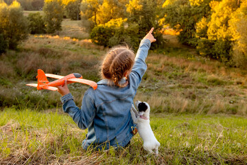 A girl walks with her little puppy