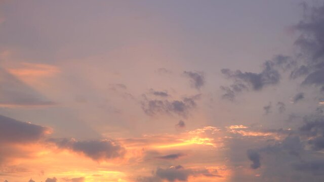   Beautiful evening blue sky at sunset with flaming bright light clouds. A warm summer evening at sunset. Bright sunset.