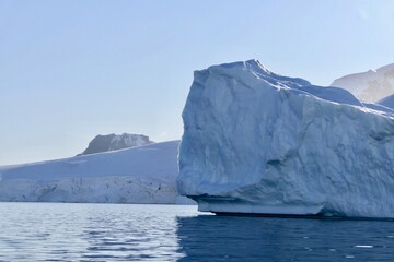 Fototapeta na wymiar Melting iceberg, antarctic ocean, blue sky, sun, melting ice, Antarctica
