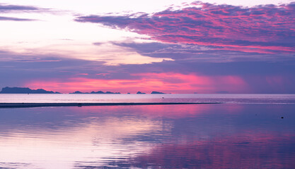 Naklejka na ściany i meble Panoramic tropical purple sea sky sunset with golden light background ,long exposure