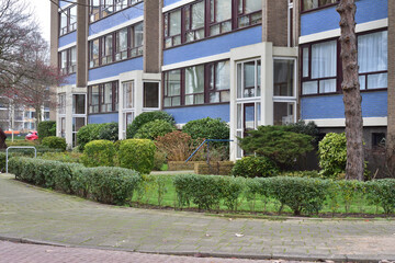 Fototapeta premium Residential houses among green bushes overcast day.