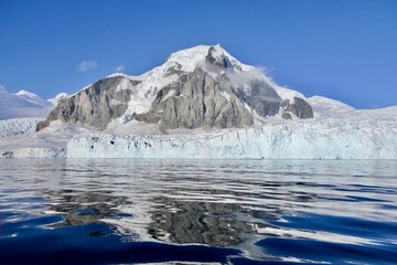 Antarctic landscape, glacier and mountain reflection in water, Antarctica