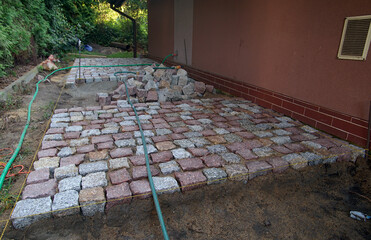 building a path in the garden of granite paving stones