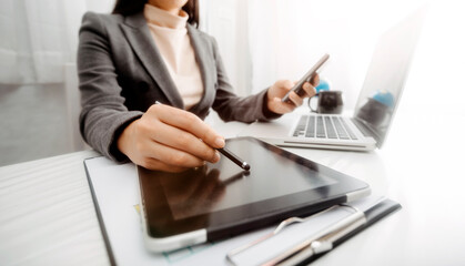 businesswoman hand using smart phone,mobile p payments online shopping,omni channel,digital tablet docking keyboard computer at office in sun light