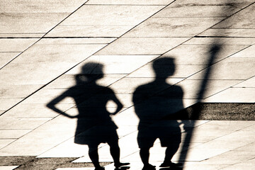 Shadow silhouette of two young people walking or waiting