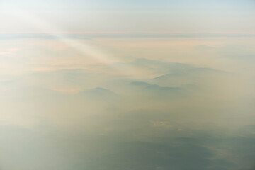 morning scenic with ray of light above mountains and clouds