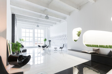 Luxurious futuristic trendy modern interior in contrasting black and white colors with interesting fashionable black furniture and decorated wall