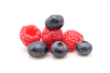 blueberries and raspberries on white background