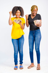 young black beautiful ladies holding some naira note/bills and jubilating over winning the money