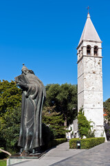 Gregory of Nin statue and bell tower in Split - Dalmacia, Croatia. Because of the popular belief that rubbing the bishop's toe brings good luck, the toe is now smooth and shiny.