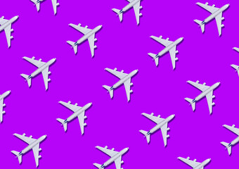 Planes patttern on purple  background with top view and copy space. Travel background for travel agency banner. Flat  lay. Minimalism travel concept.