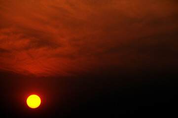 The setting sun is burning the African sky as night announces itself