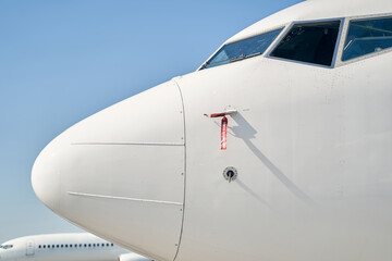 Nose of an airplane against the blue sky