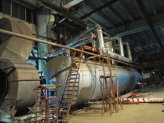 Fototapeta na wymiar Pipes, steel tubes, steam turbine and equipment at power plant, night scene