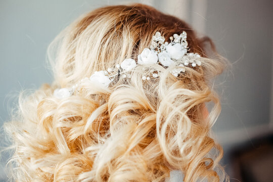 flower wreath in the hair, decoration on the head of the bride from fresh flowers, wedding day, image of the bride