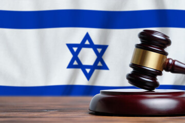 Justice and court concept in State of Israel. Judge hammer on a flag background