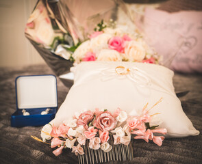 Wedding set with all bride's accessories, wedding rings, bouquet, flowers headdress and earrings. Beautiful moment of wedding day