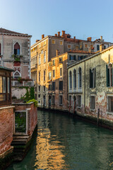 View of the  water channels, bridges and old palaces in Venice at sunrise during the lockdown