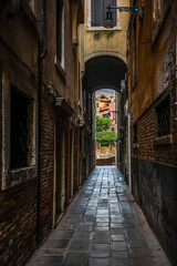 Fototapeta na wymiar The light and shadows in the empty narrow alleys of Venice during the coronavirus