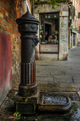 A drinking water fountain in Venice early in a summer morning