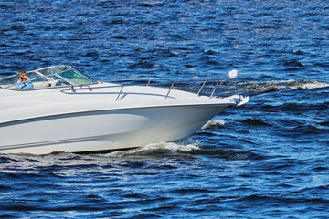 Fototapeta premium Modern fashionable speed boat sails in the sea.