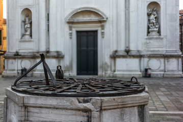 Detail of the wrought iron of a drinking water well in Venice in the courtyart of a church