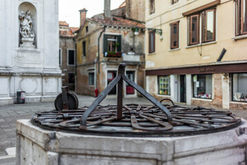 Detail of the wrought iron of a drinking water well in Venice in the courtyart of a church